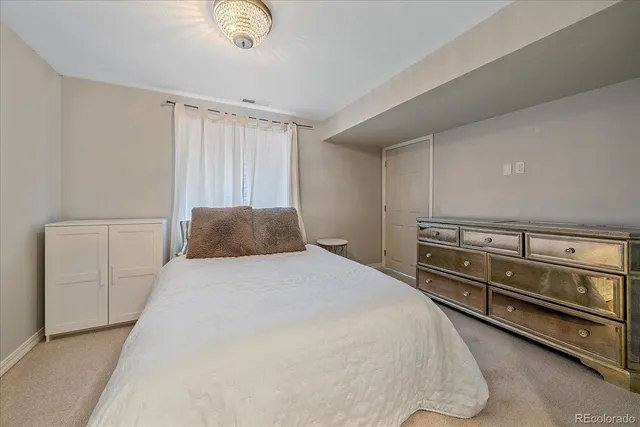 a bedroom with a bed and cabinets
