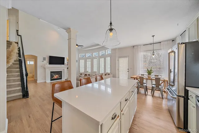 a large white kitchen with a table and chairs