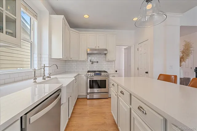 a kitchen with a sink stove and cabinets