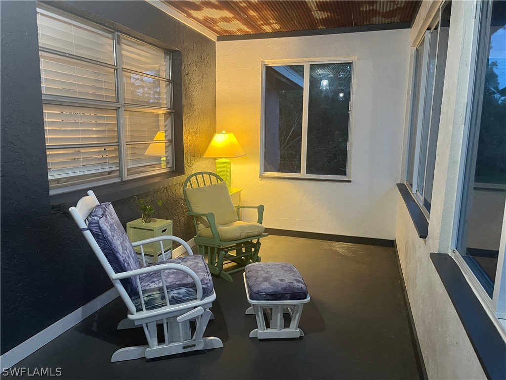 13100 Rod And Gun Club Road Fort Myers, FL 33913 - Photo 5 of 37 a living room with a chair and a large window