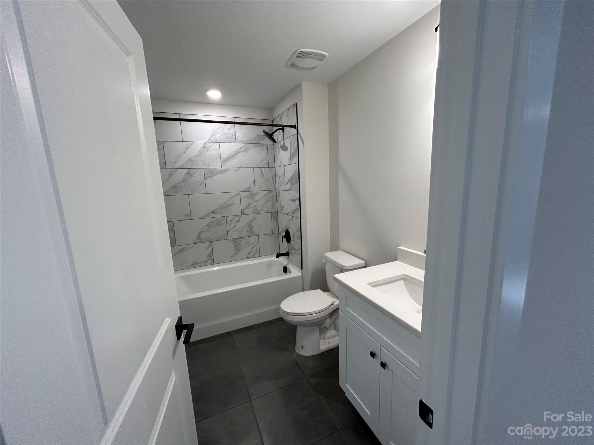 302 Lester Davis Road Waxhaw, NC 28173 - Photo 25 of 43 a bathroom with a granite countertop sink toilet a mirror and shower