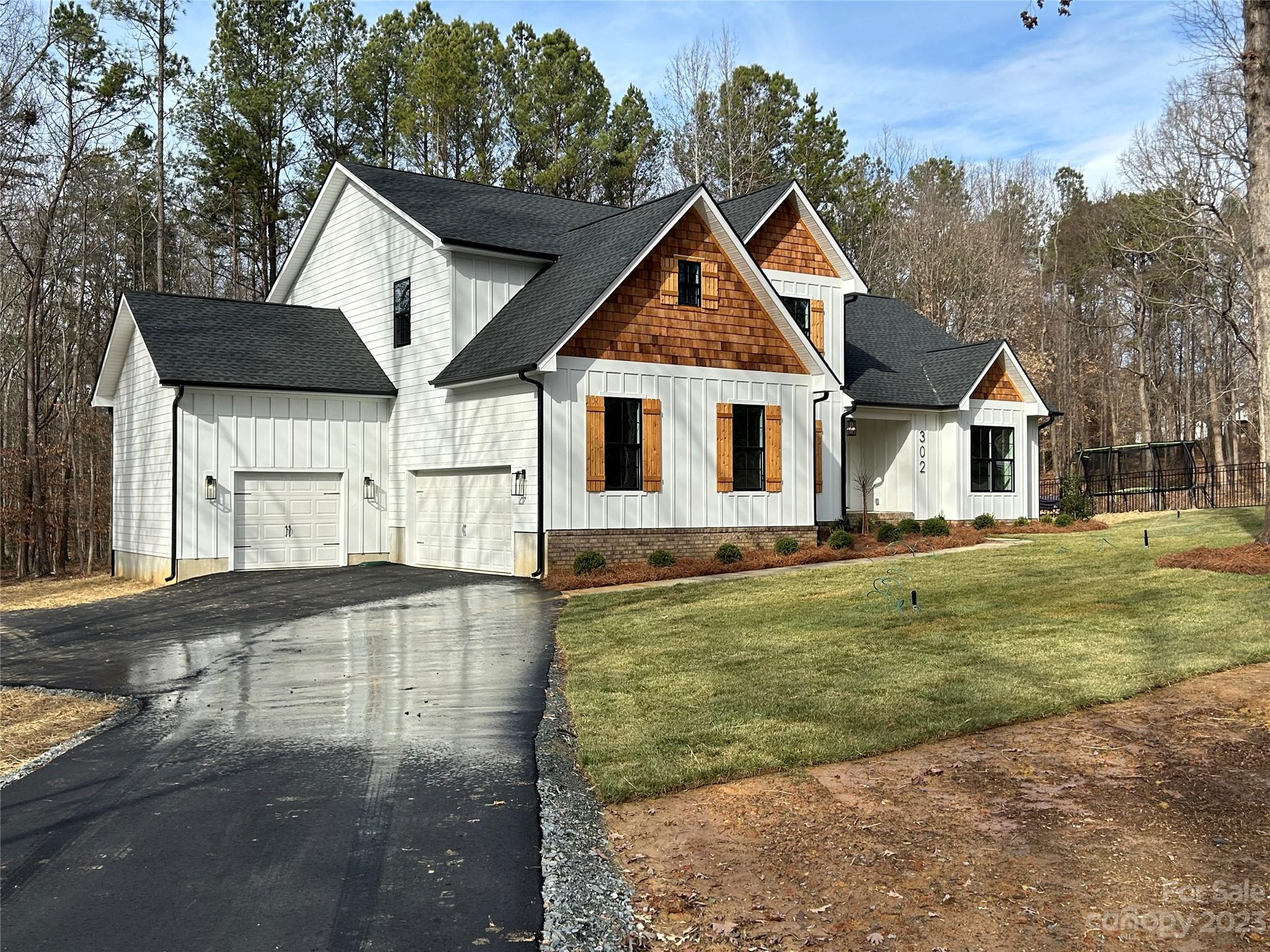 302 Lester Davis Road Waxhaw, NC 28173 - Photo 3 of 43 a view of a yard in front of a house with a large tree