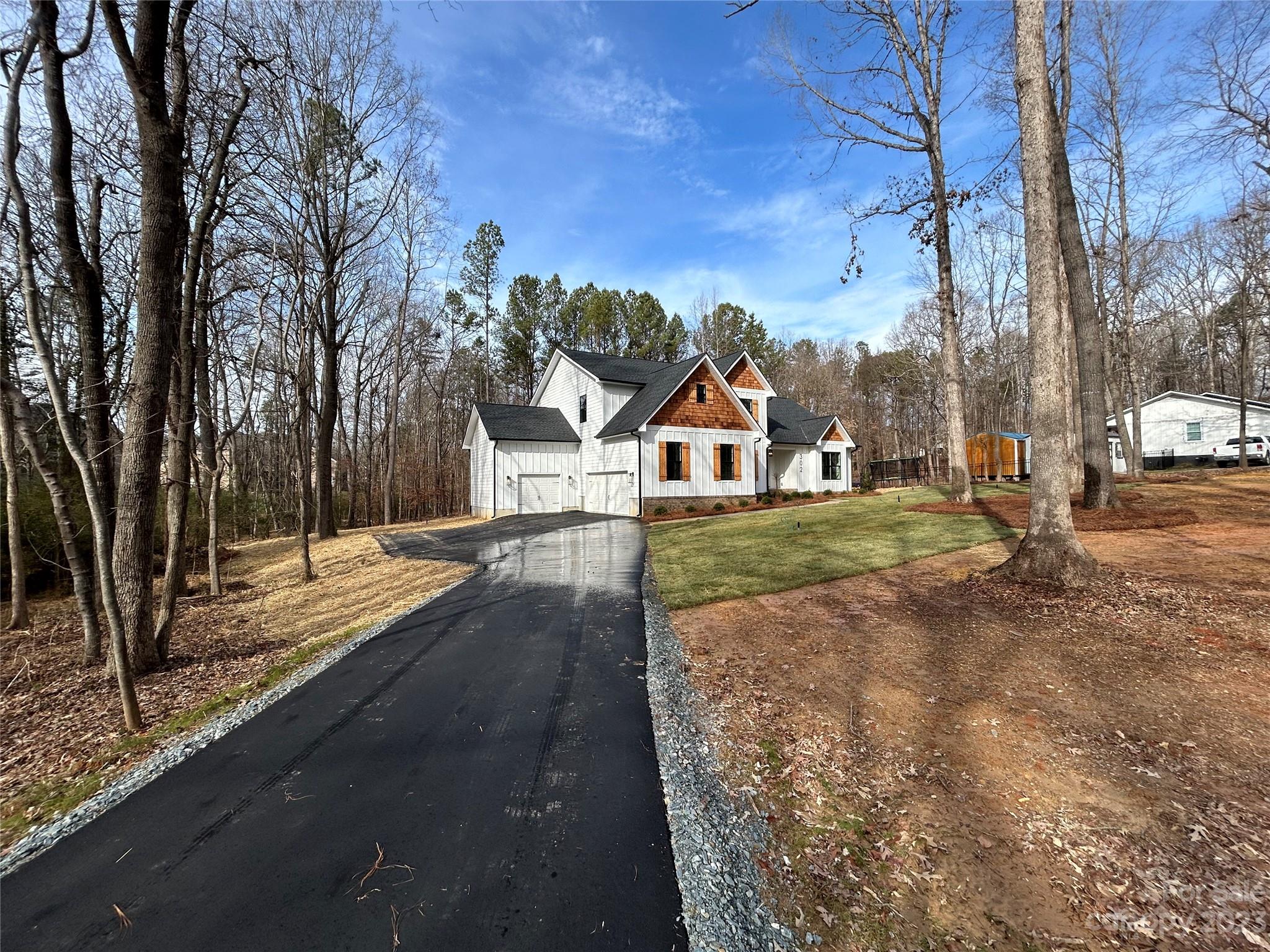 302 Lester Davis Road Waxhaw, NC 28173 - Photo 8 of 43 a view of a yard with plants and a trees