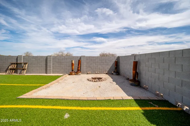a view of a backyard with sitting area