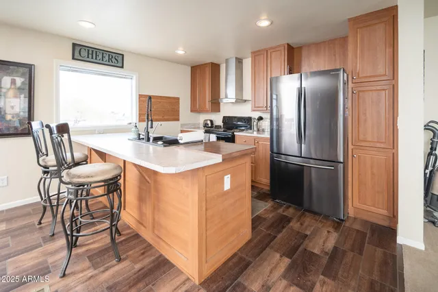 a kitchen with stainless steel appliances granite countertop a sink a stove and a microwave