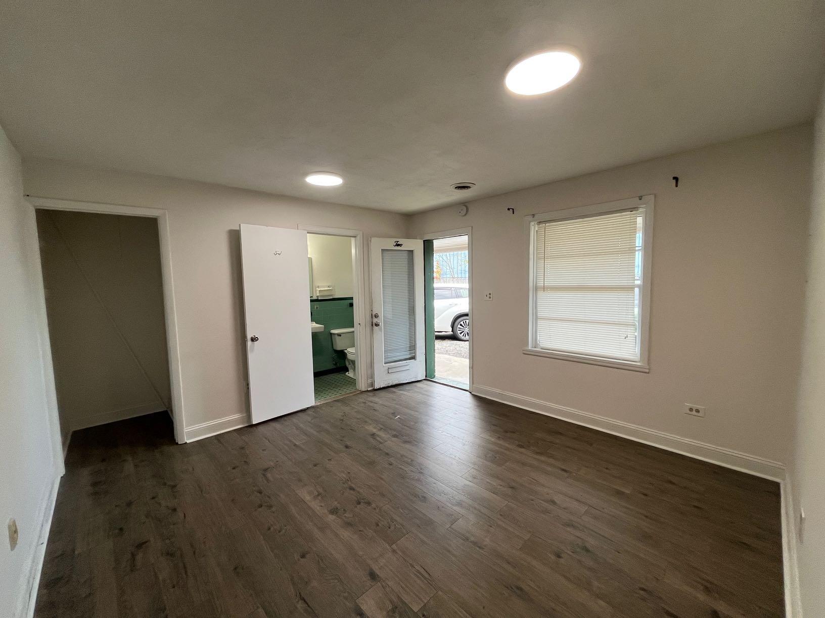 7629 Williamson Road, Unit 2 Roanoke, VA 24019 - Photo 3 of 5 an empty room with wooden floor and windows