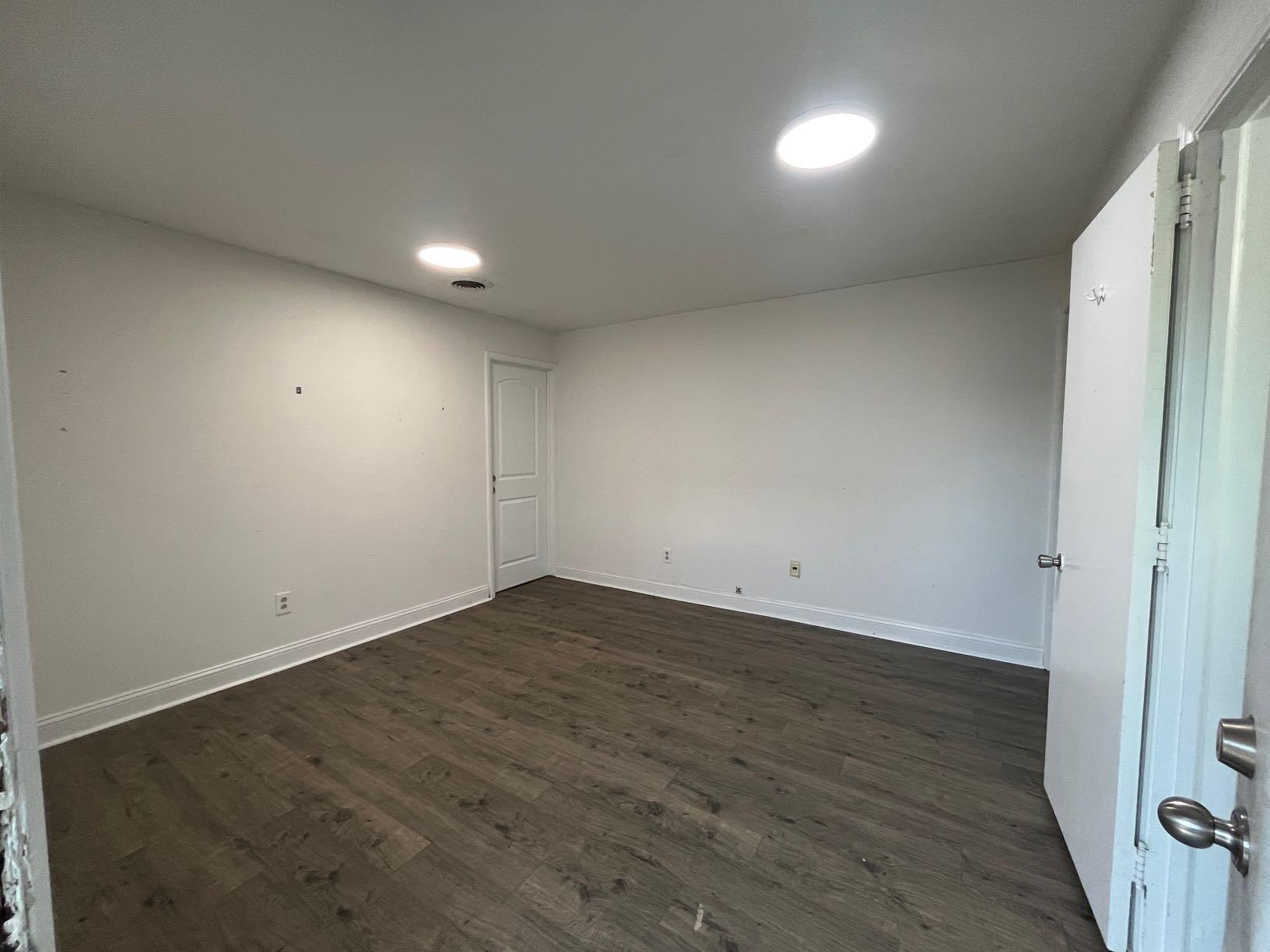 7629 Williamson Road, Unit 2 Roanoke, VA 24019 - Photo 5 of 5 an empty room with wooden floor and windows