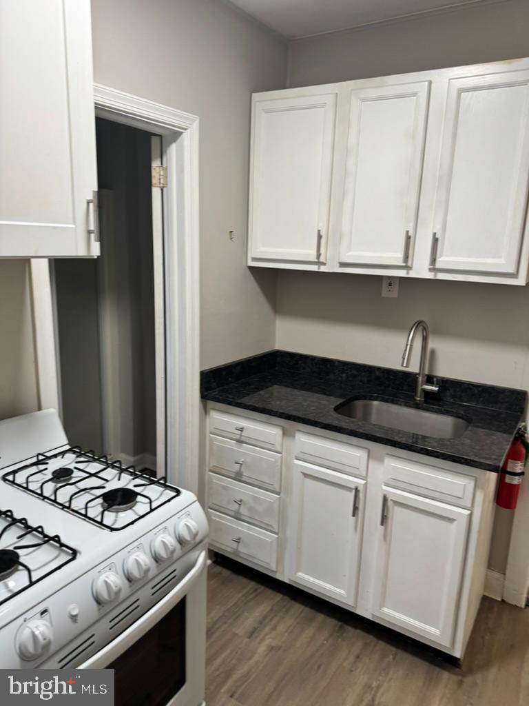 202-206 South Main Street Hatfield, PA 19440 - Photo 3 of 8 a kitchen with granite countertop white cabinets and white stove
