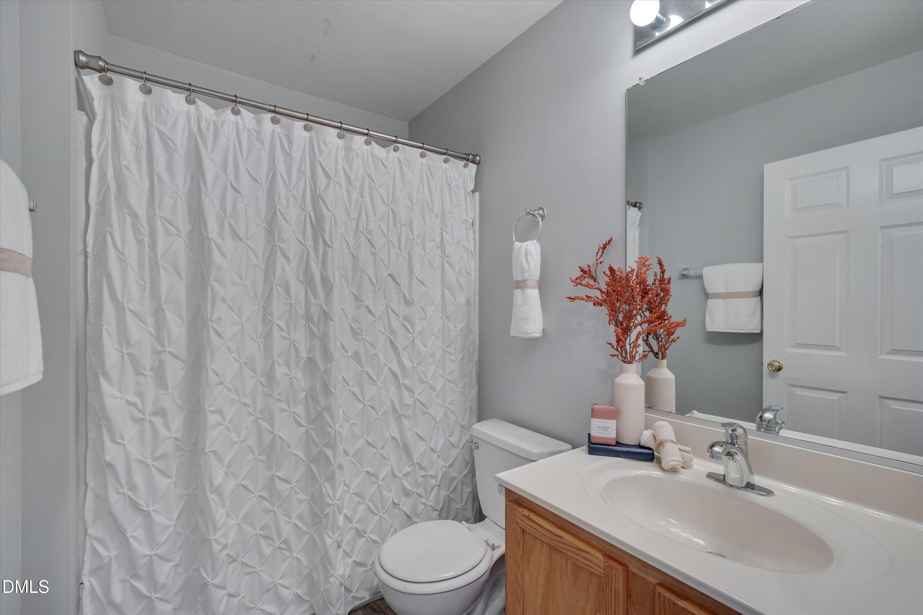 2621 Ivory Run Way, Unit 105 Raleigh, NC 27603 - Photo 15 of 21 a bathroom with a sink toilet and shower