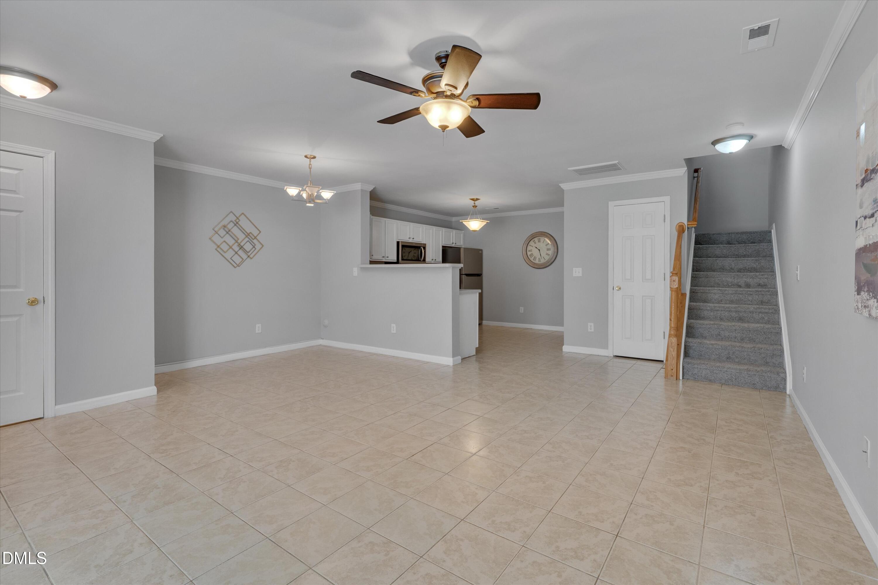 2621 Ivory Run Way, Unit 105 Raleigh, NC 27603 - Photo 5 of 21 a view of an empty room with a ceiling fan