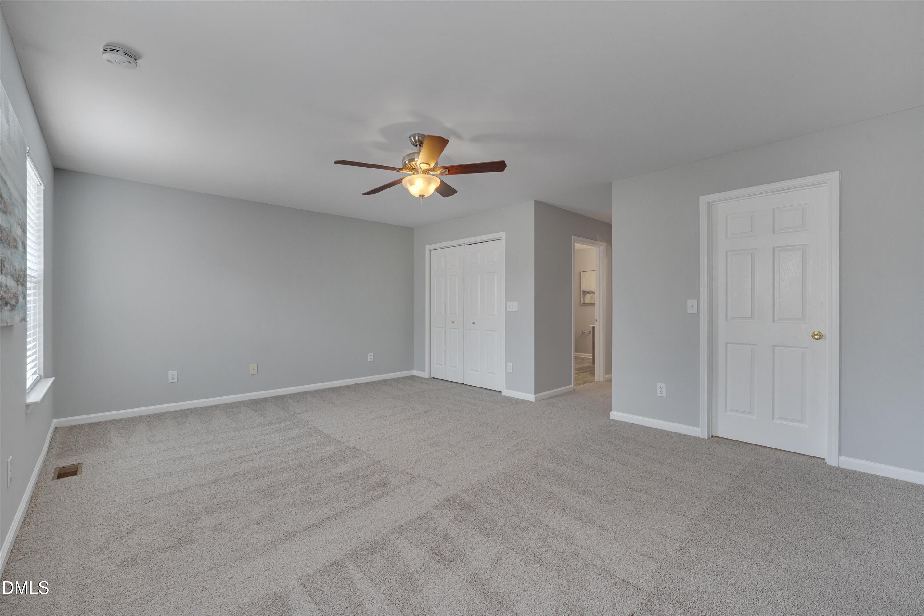2621 Ivory Run Way, Unit 105 Raleigh, NC 27603 - Photo 9 of 21 a view of an empty room with a window