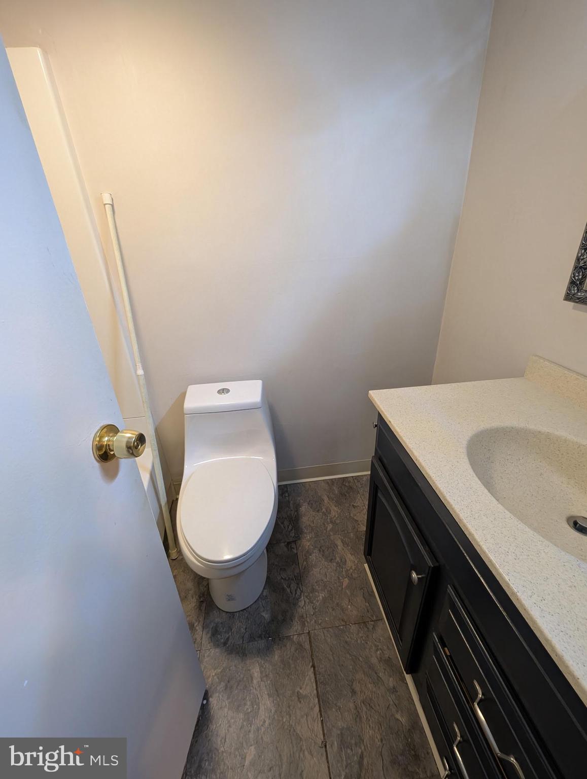 280 Bridgewater Road, Unit D1 Brookhaven, PA 19015 - Photo 10 of 15 a bathroom with a granite countertop toilet and a sink