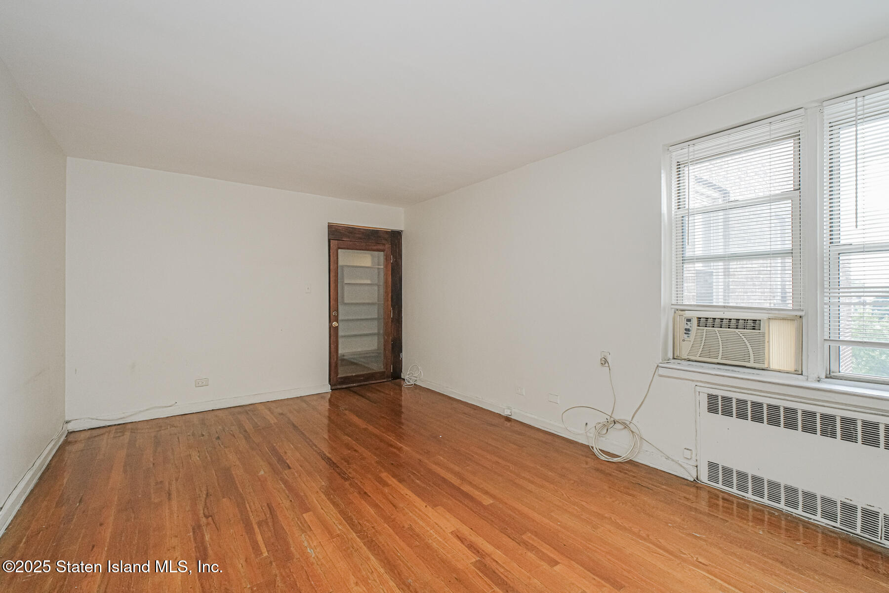 36 Dahill Road, Unit 4F Brooklyn, NY 11218 - Photo 17 of 25 an empty room with wooden floor and windows