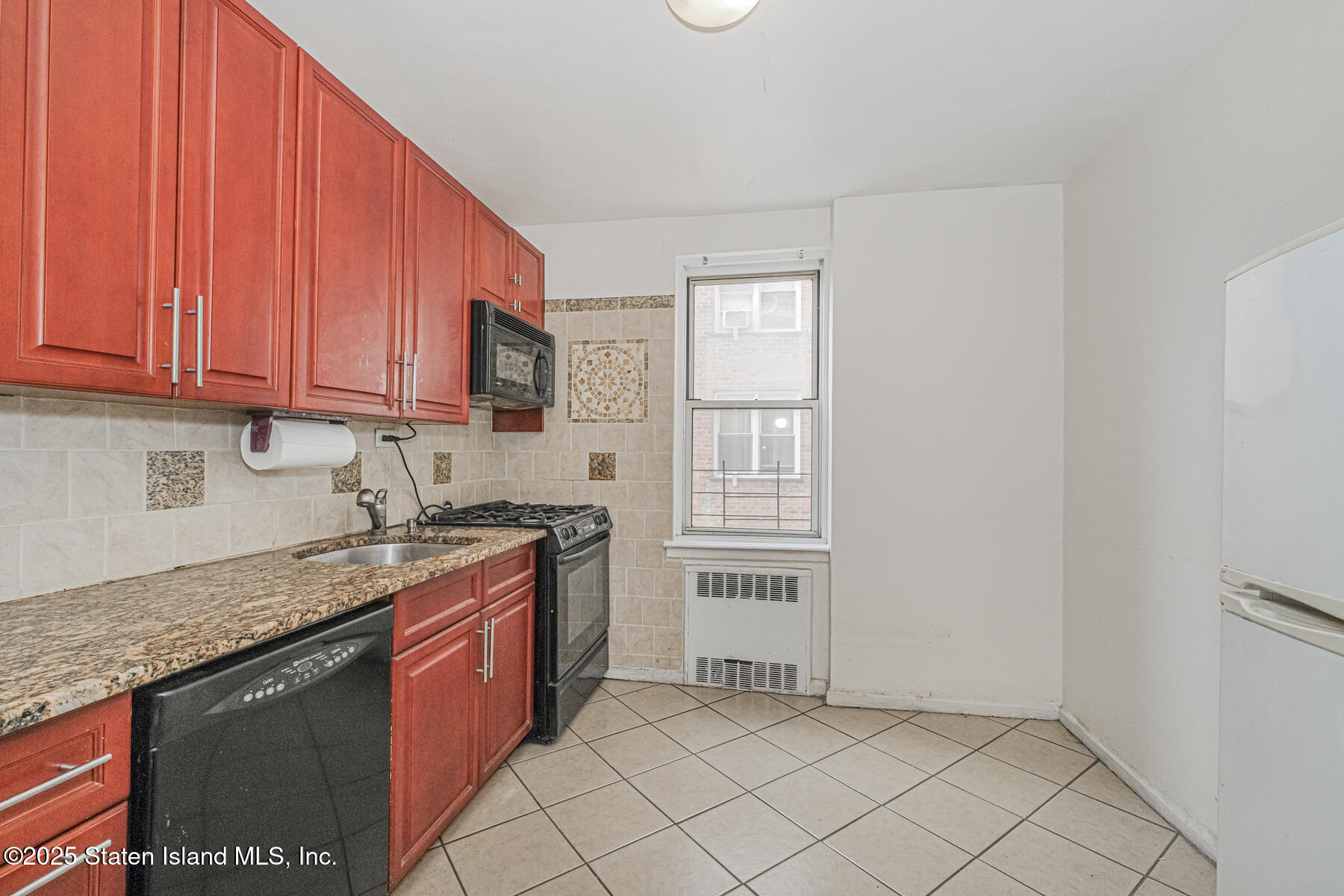 36 Dahill Road, Unit 4F Brooklyn, NY 11218 - Photo 8 of 25 a kitchen with stainless steel appliances granite countertop a stove a sink and a refrigerator