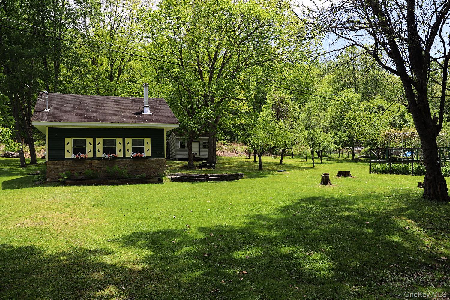 860 River Road Callicoon, NY 12723 - Photo 43 of 45 a view of a house with a backyard and a tree