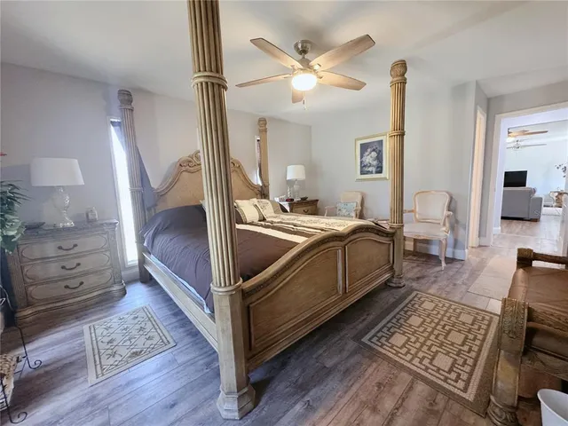a bedroom with a bed and wooden floor