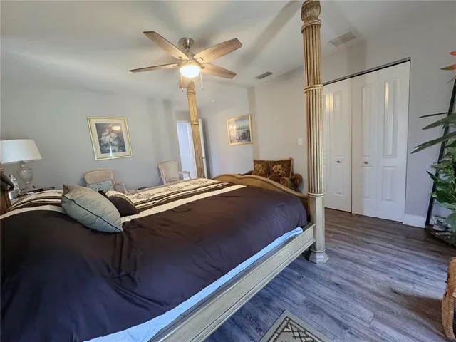 a bed room with a bed mirror and a chandelier