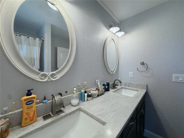 a bathroom with a sink a toilet and mirror