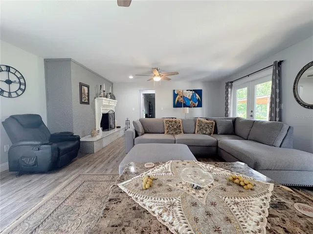 a view of a swimming pool with a yard and sitting area