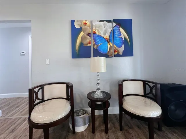 a view of a green yard with a house and large trees