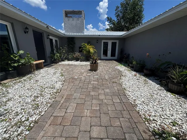 a living room with furniture a rug and a chandelier