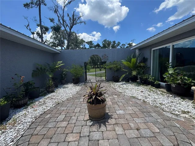 a living room with furniture a flat screen tv and a table