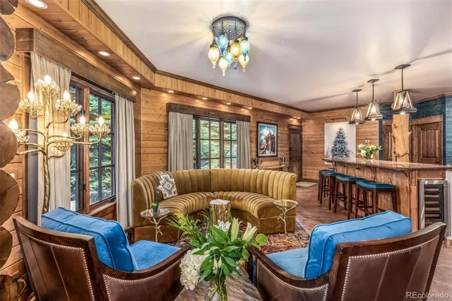 a living room with furniture a lamp and a large window