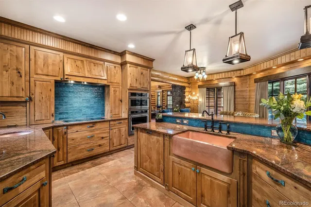 a view of a kitchen with kitchen island a sink and a stove