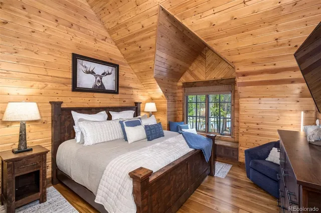 a bathroom with a granite countertop sink a mirror and shower