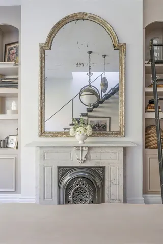 a dining room with furniture and a large window