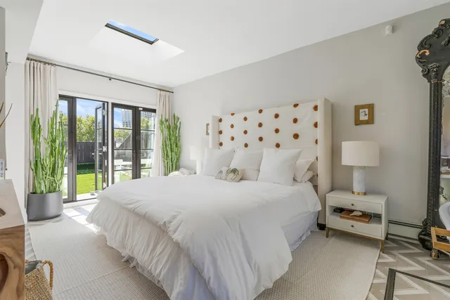 a bedroom with a bed and a mirror