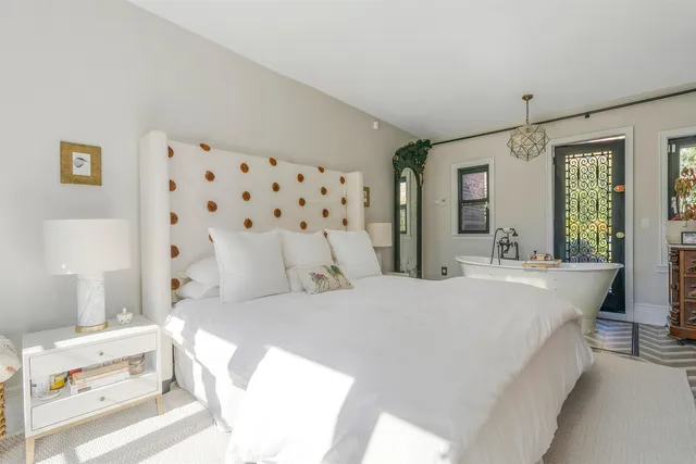 a bedroom with a bed and a large window