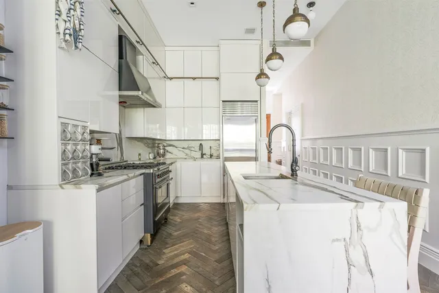 a living room with furniture a window and kitchen view