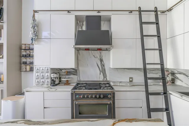 a living room with couches a table and chairs with outer view