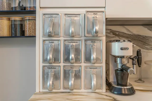 a kitchen with stainless steel appliances granite countertop a sink a stove and a refrigerator