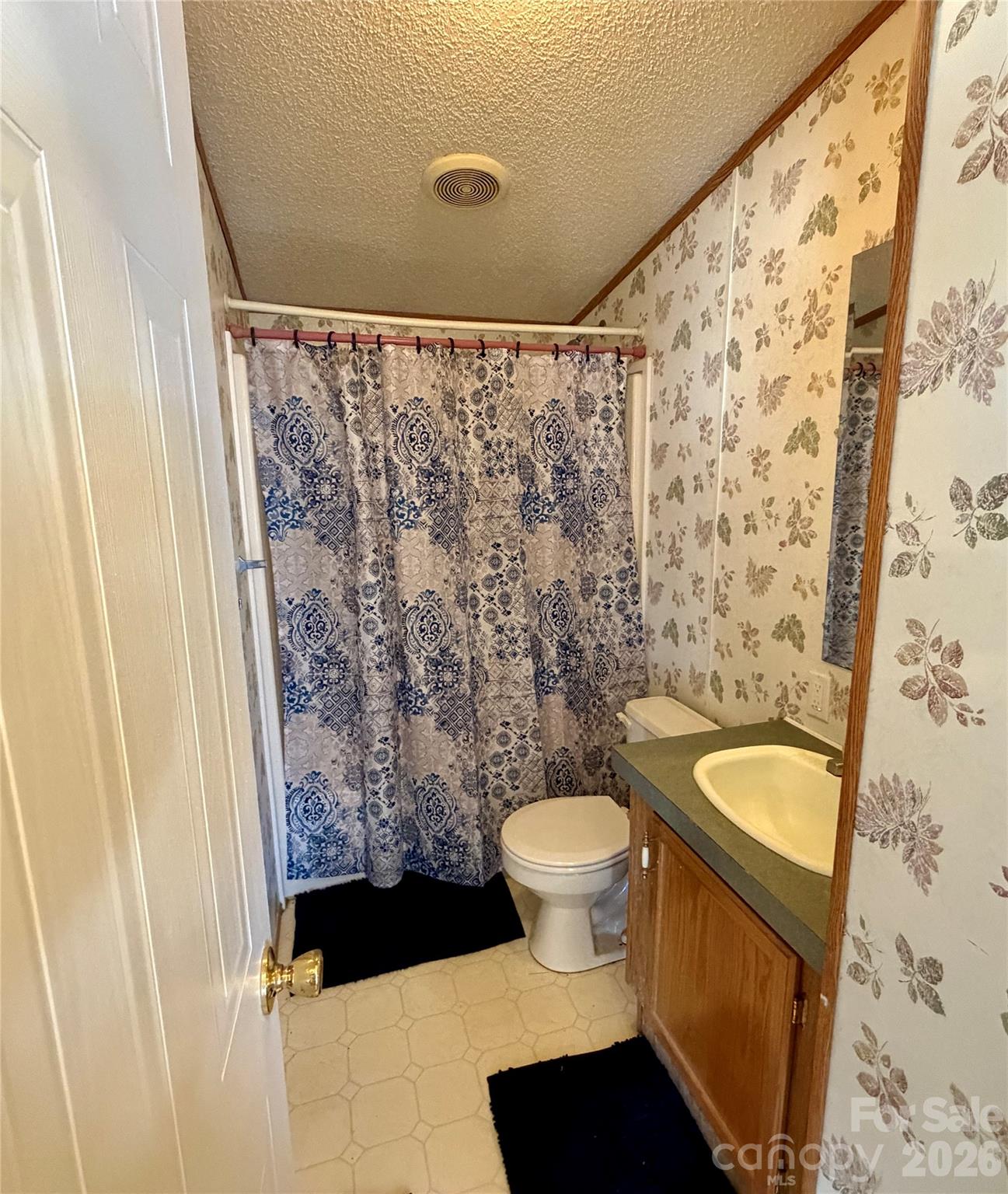 2390 Claremont Road Newton, NC 28658 - Photo 7 of 11 a bathroom with a toilet and a shower curtain