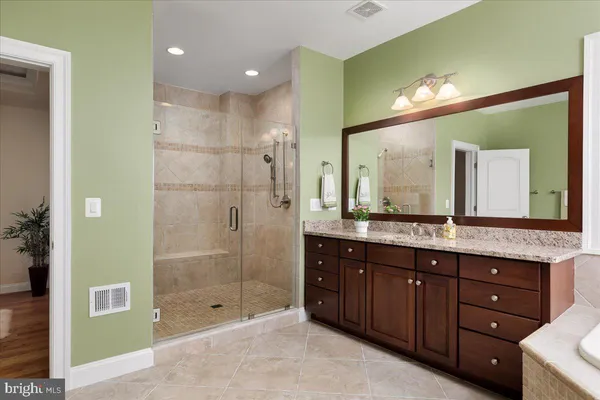 a bathroom with a granite countertop sink and a mirror