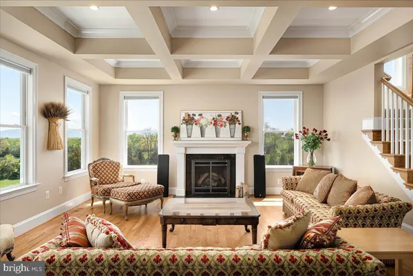 a living room with fireplace furniture and a large window
