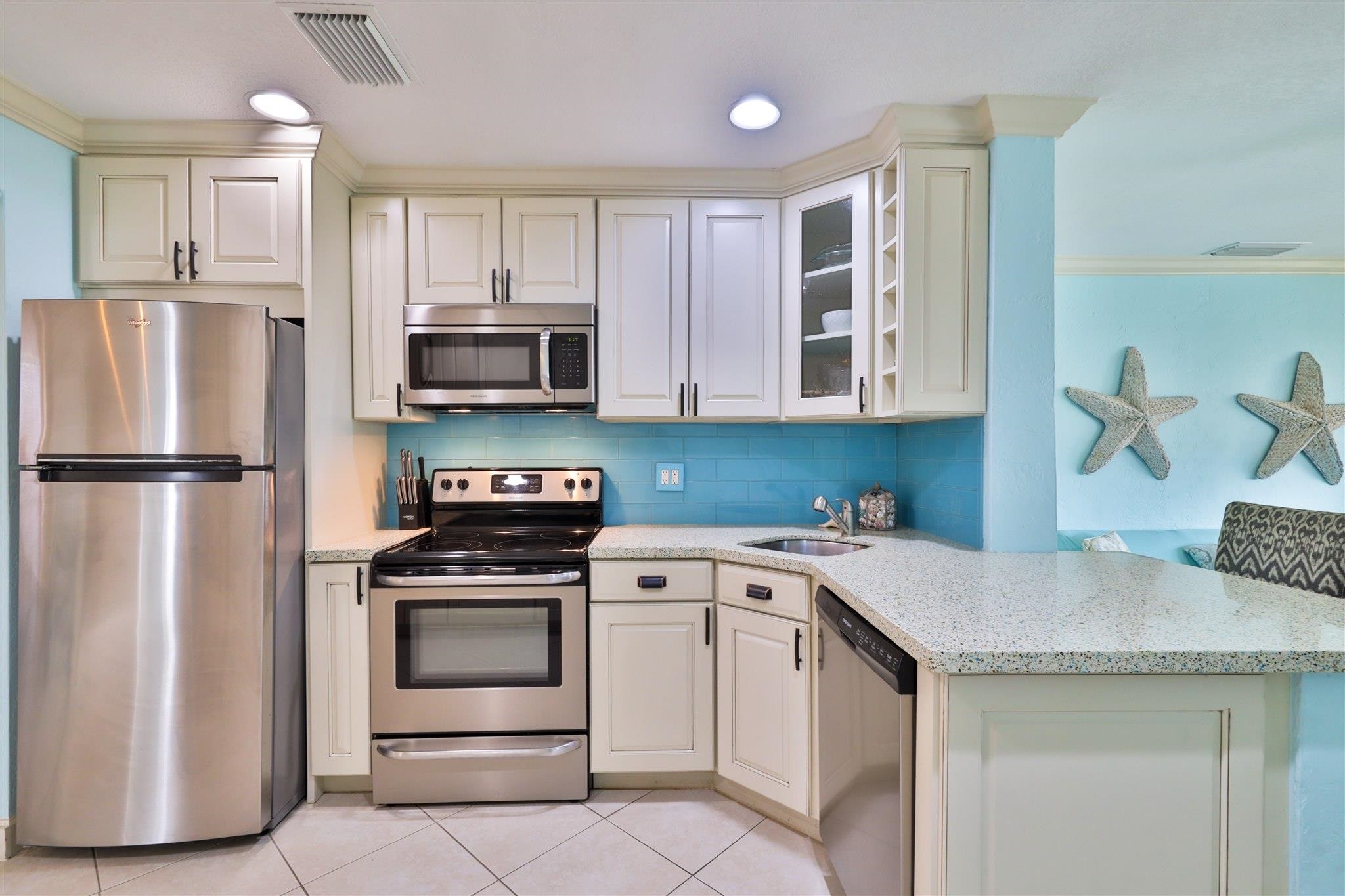 7 Azalea Drive Ormond Beach, FL 32176 - Photo 11 of 46 a kitchen with a stove microwave and refrigerator
