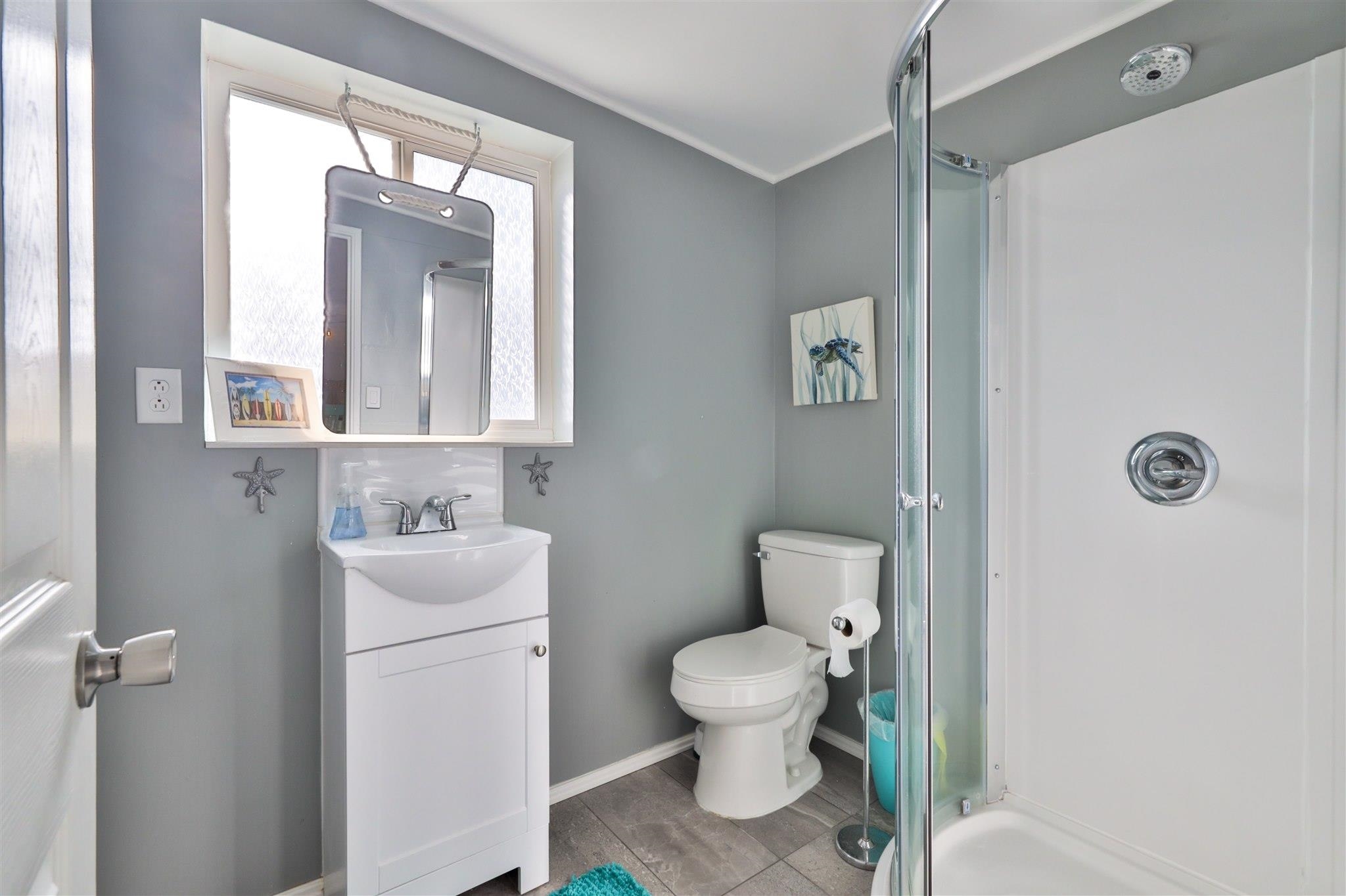 7 Azalea Drive Ormond Beach, FL 32176 - Photo 14 of 46 a bathroom with a toilet sink and mirror