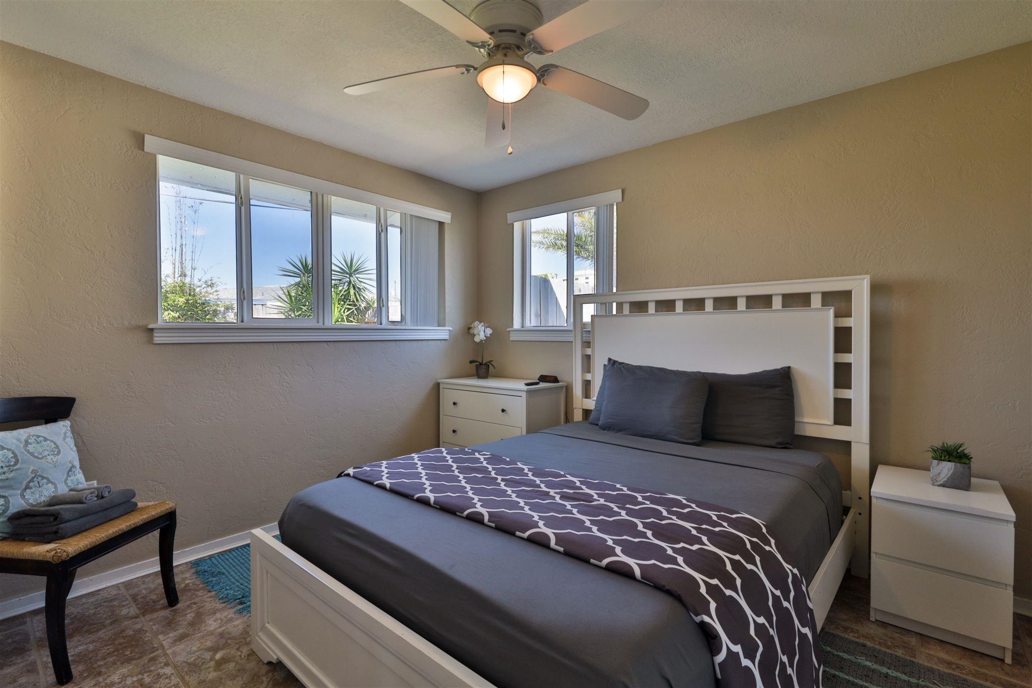 7 Azalea Drive Ormond Beach, FL 32176 - Photo 15 of 46 a bedroom with a bed and a chandelier