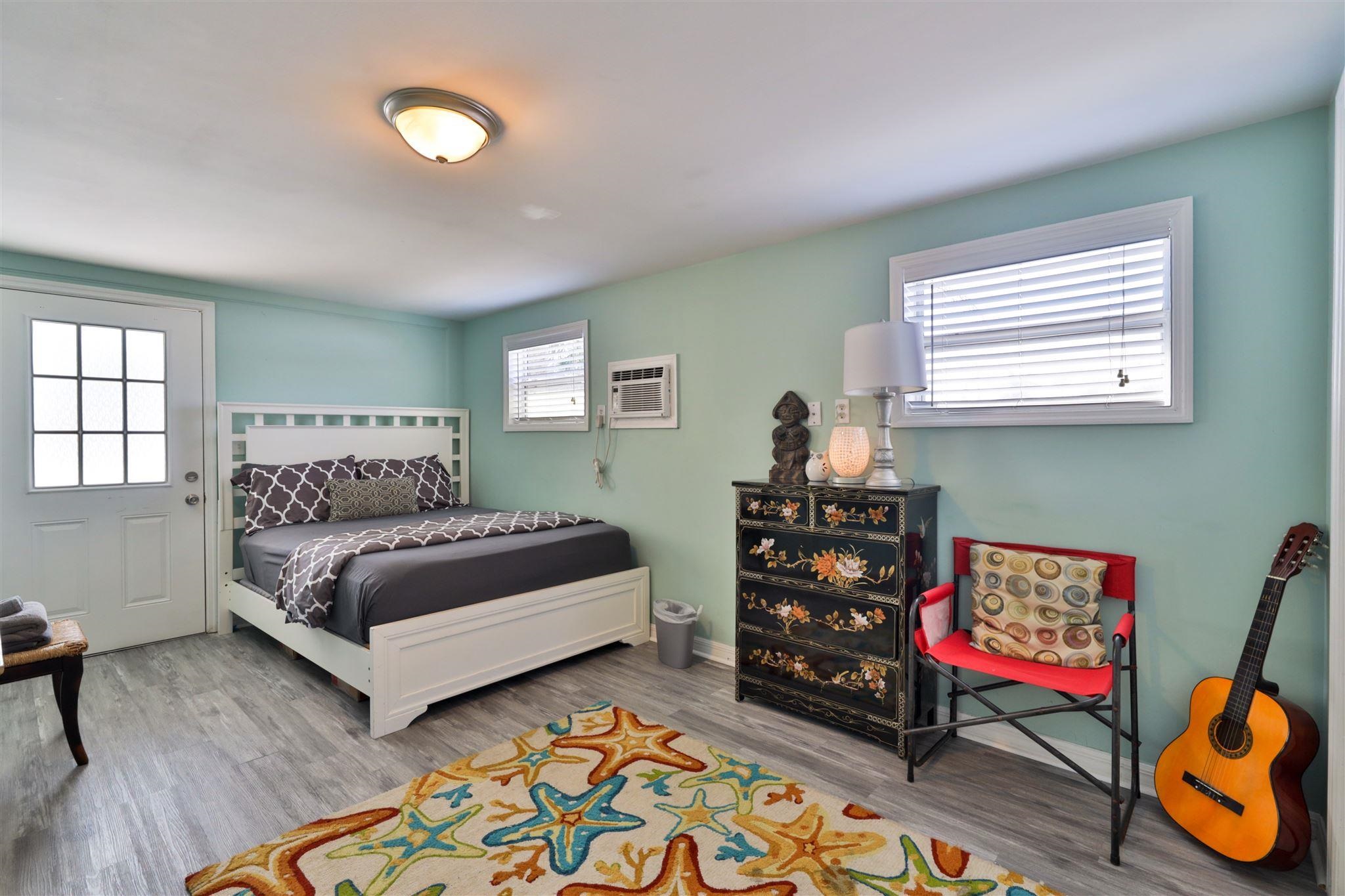 7 Azalea Drive Ormond Beach, FL 32176 - Photo 17 of 46 a bedroom with a bed a dresser and a window