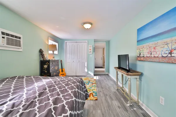 a bedroom with a bed and a flat screen tv