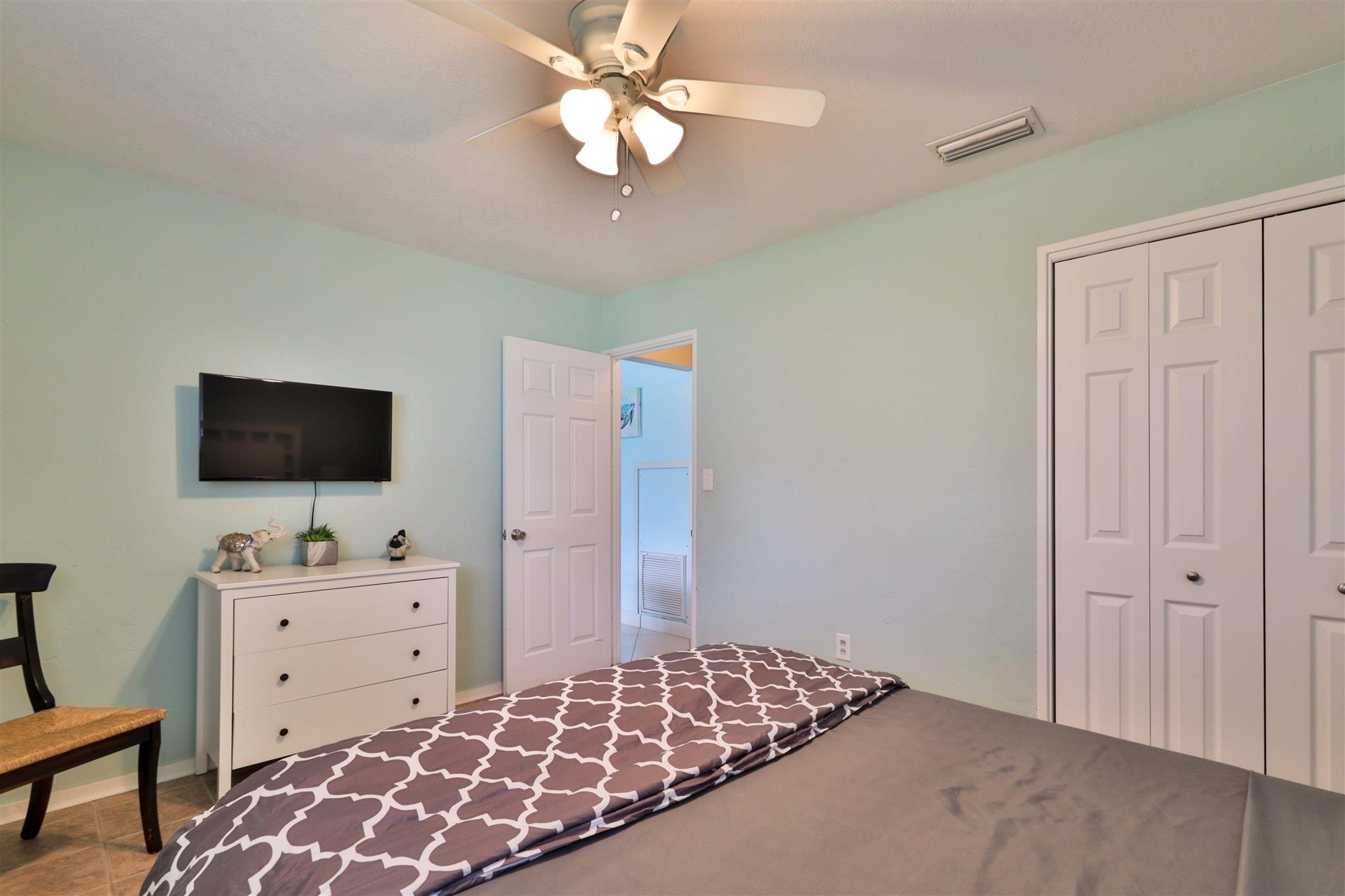 7 Azalea Drive Ormond Beach, FL 32176 - Photo 20 of 46 a bedroom with a bed and a flat screen tv