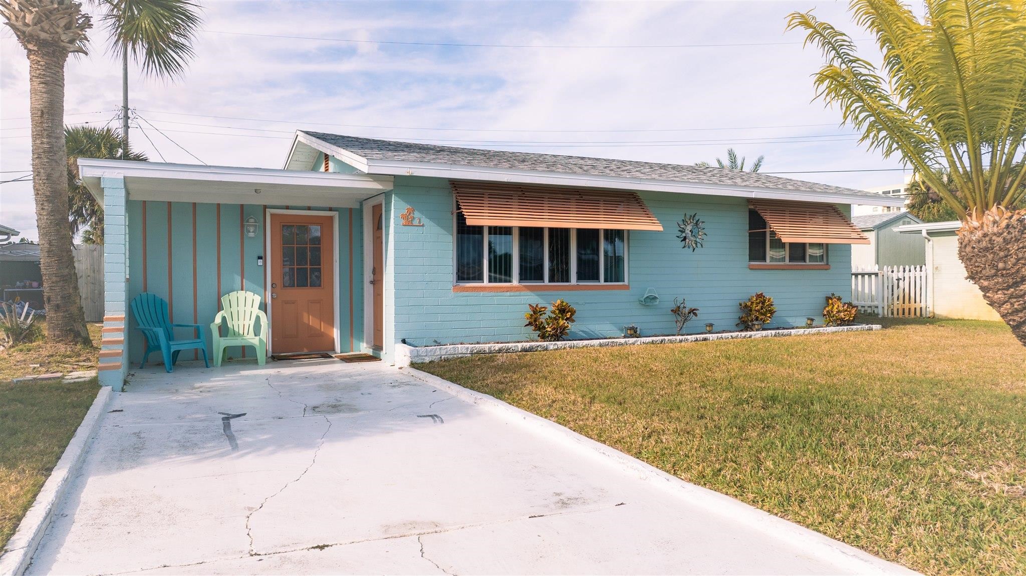 7 Azalea Drive Ormond Beach, FL 32176 - Photo 25 of 46 a front view of a house with a yard and garage