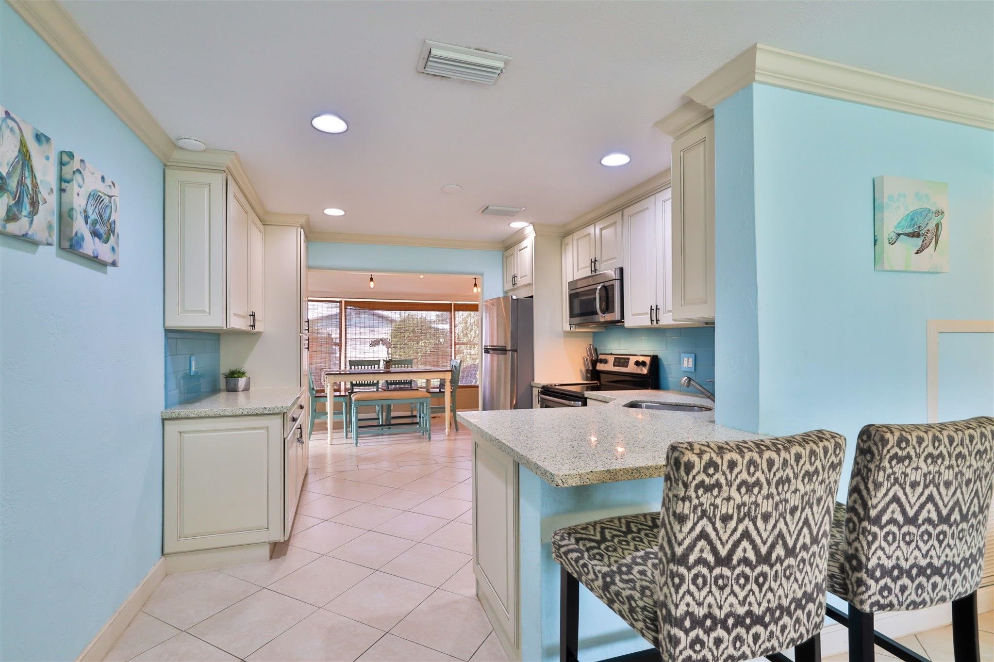7 Azalea Drive Ormond Beach, FL 32176 - Photo 10 of 46 a kitchen with granite countertop cabinets a dining table and chairs