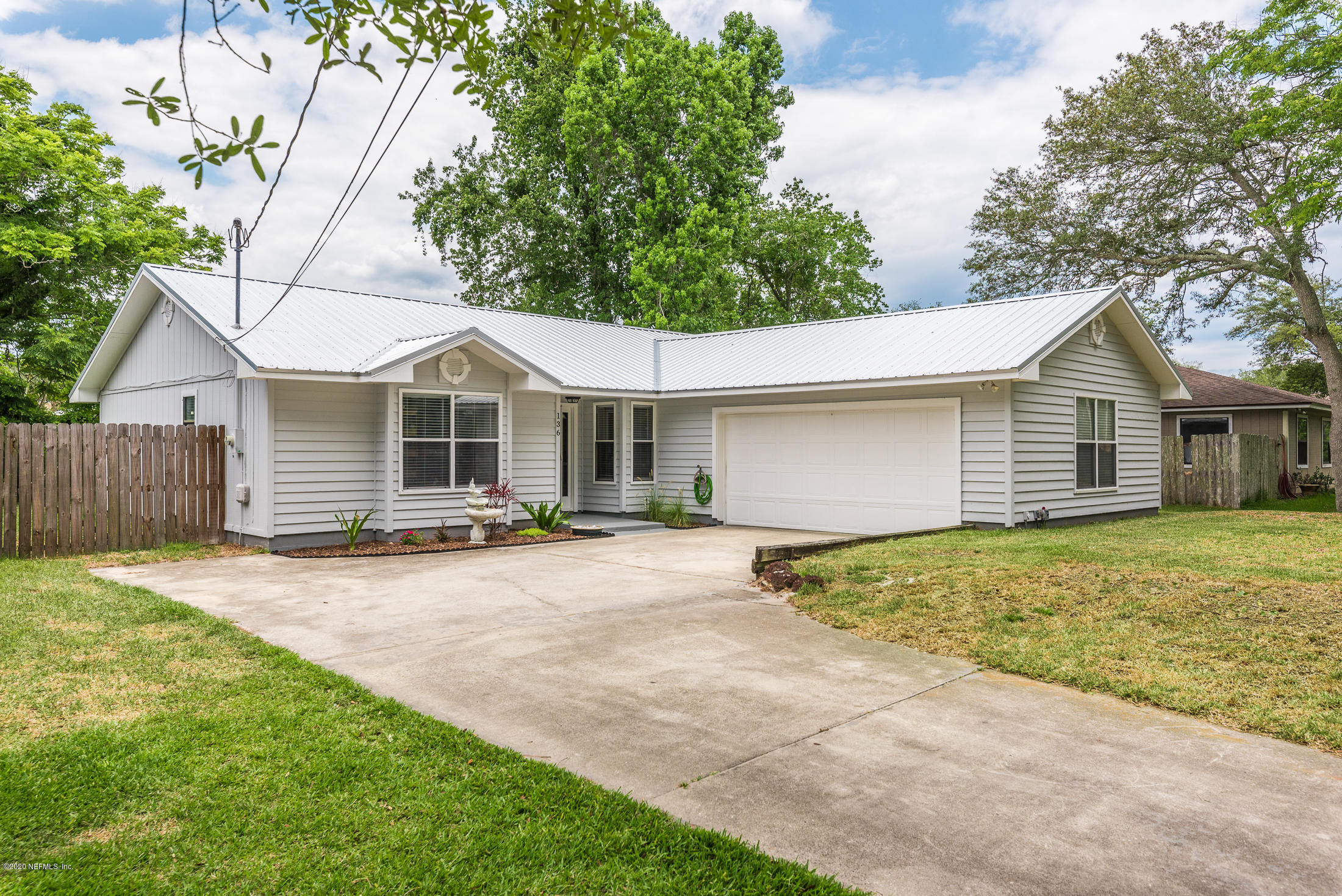 136 Wisteria Road St. Augustine, FL 32086 - Photo 2 of 39 a view of a house with a yard and large tree