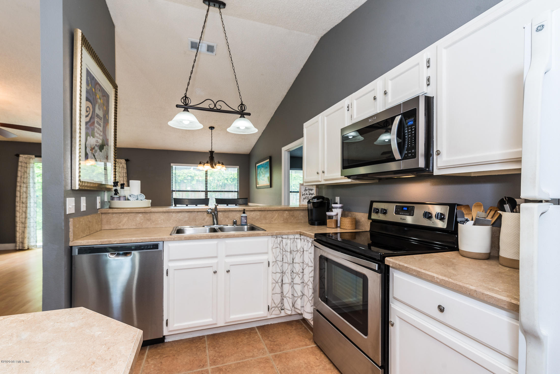 136 Wisteria Road St. Augustine, FL 32086 - Photo 23 of 39 a kitchen with a sink stove and microwave
