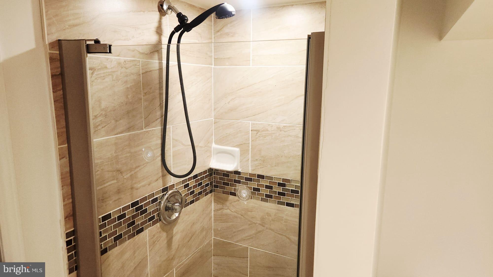 519 East 28th Street Baltimore, MD 21218 - Photo 16 of 46 Sleek modern shower with elegant tiles.