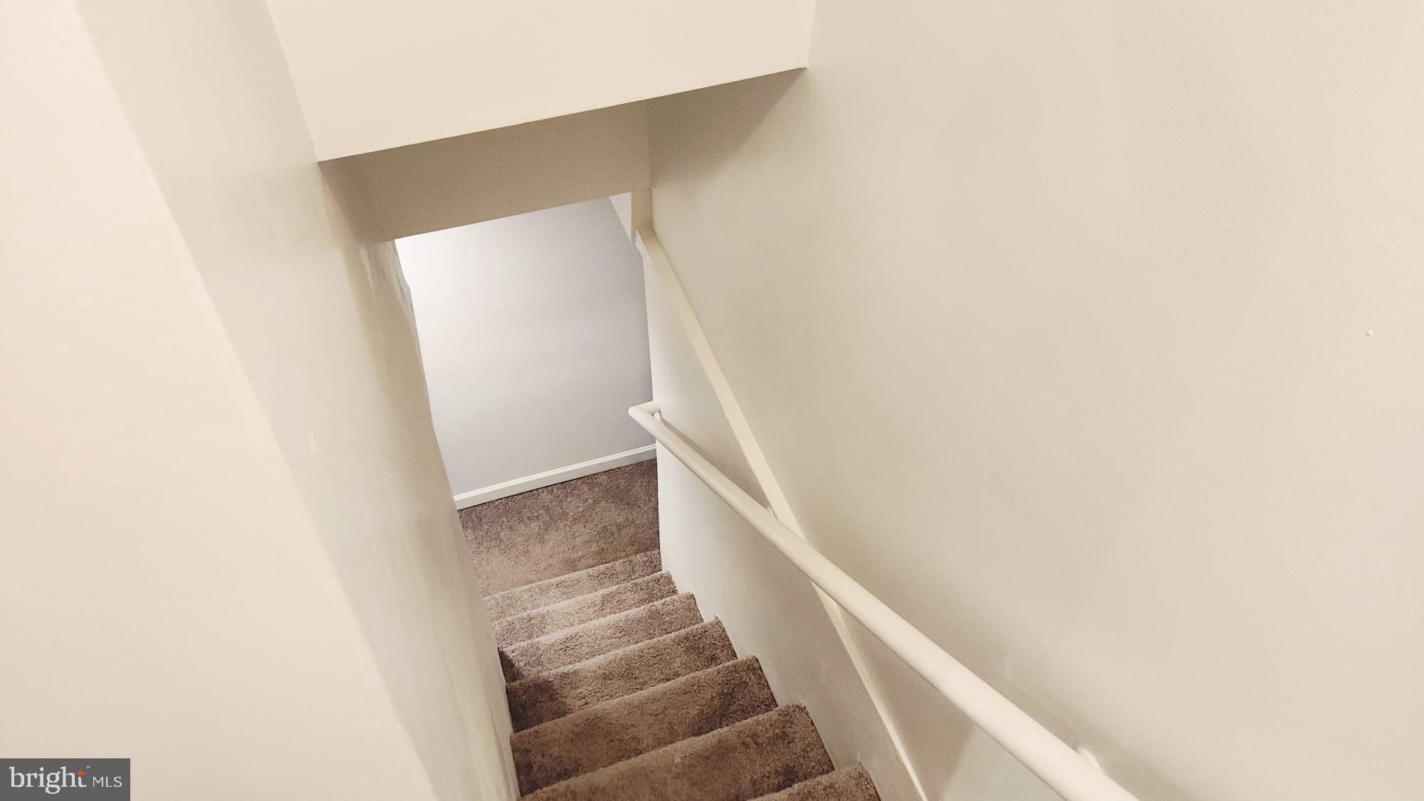 519 East 28th Street Baltimore, MD 21218 - Photo 27 of 46 Inviting descent into cozy living spaces.